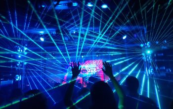 people standing on stage with blue lights