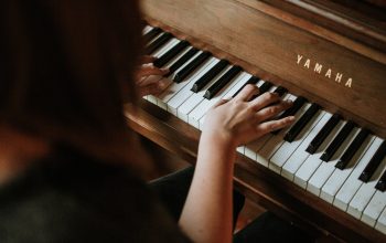 woman playing Yamaha piano