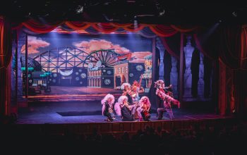 crowd of people watching a stage performance in the theater