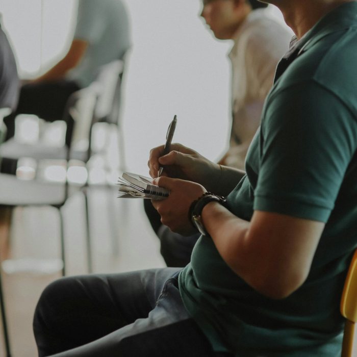 man in green crew neck t-shirt holding silver fork