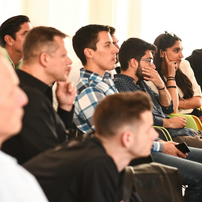 man in blue and white plaid button up shirt sitting on black chair